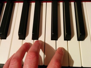 left hand on piano keys